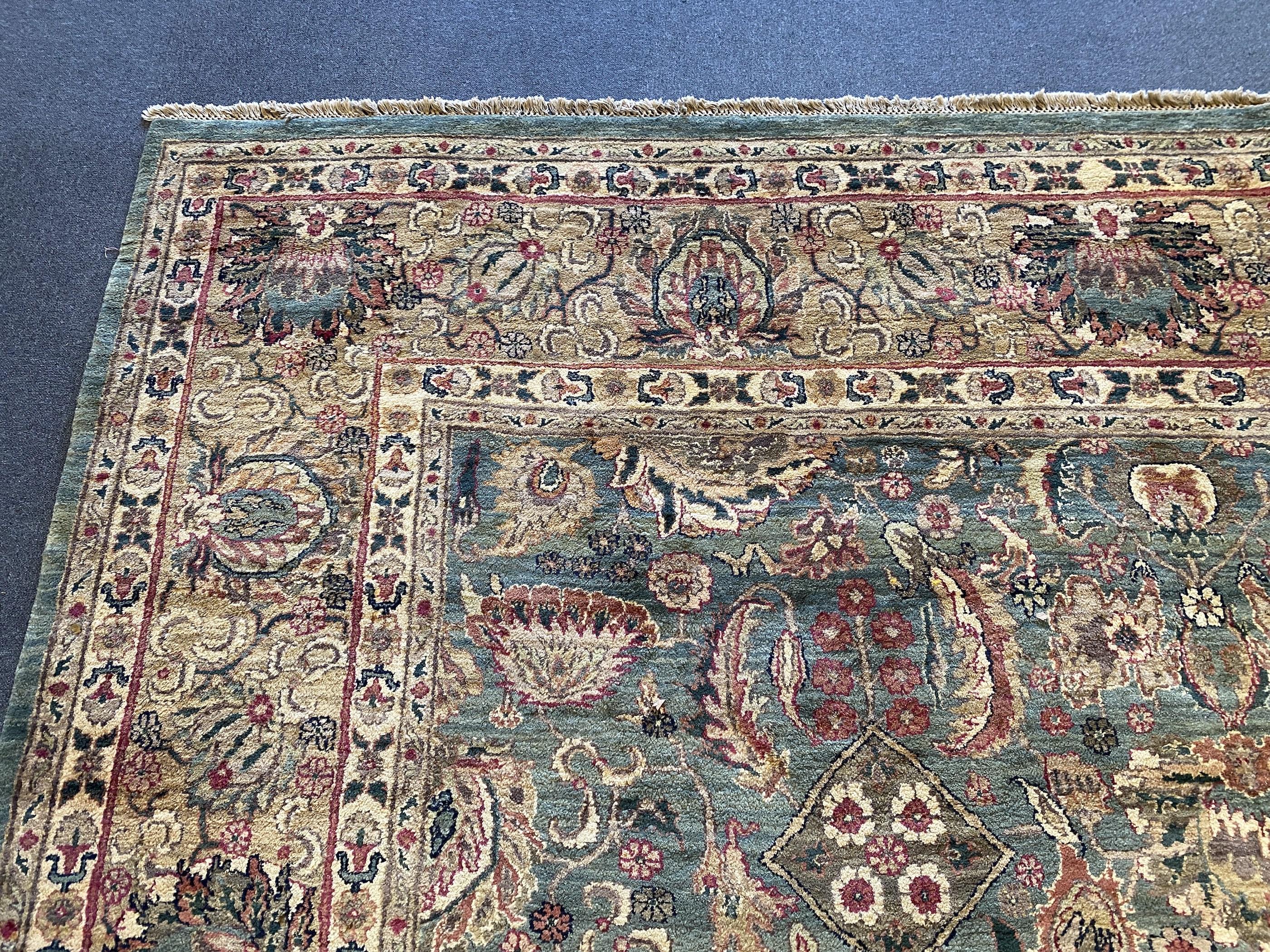 An Indian Persian style sage green ground carpet, 465 x 363cm